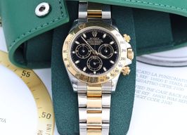 Rolex Daytona 116523 (Unknown (random serial)) - Black dial 40 mm Gold/Steel case